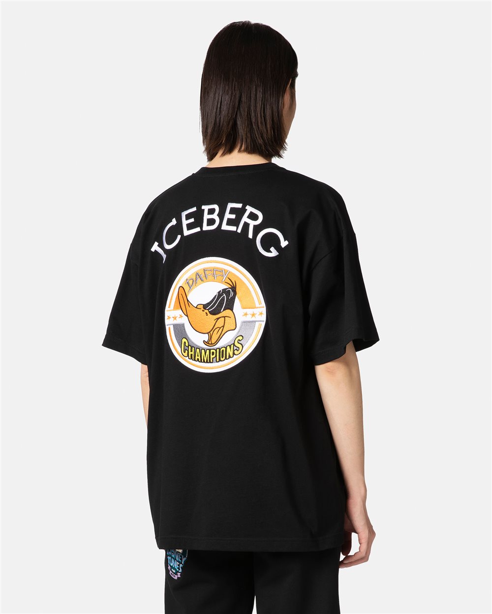 Black T-shirt with cartoon patch and logo